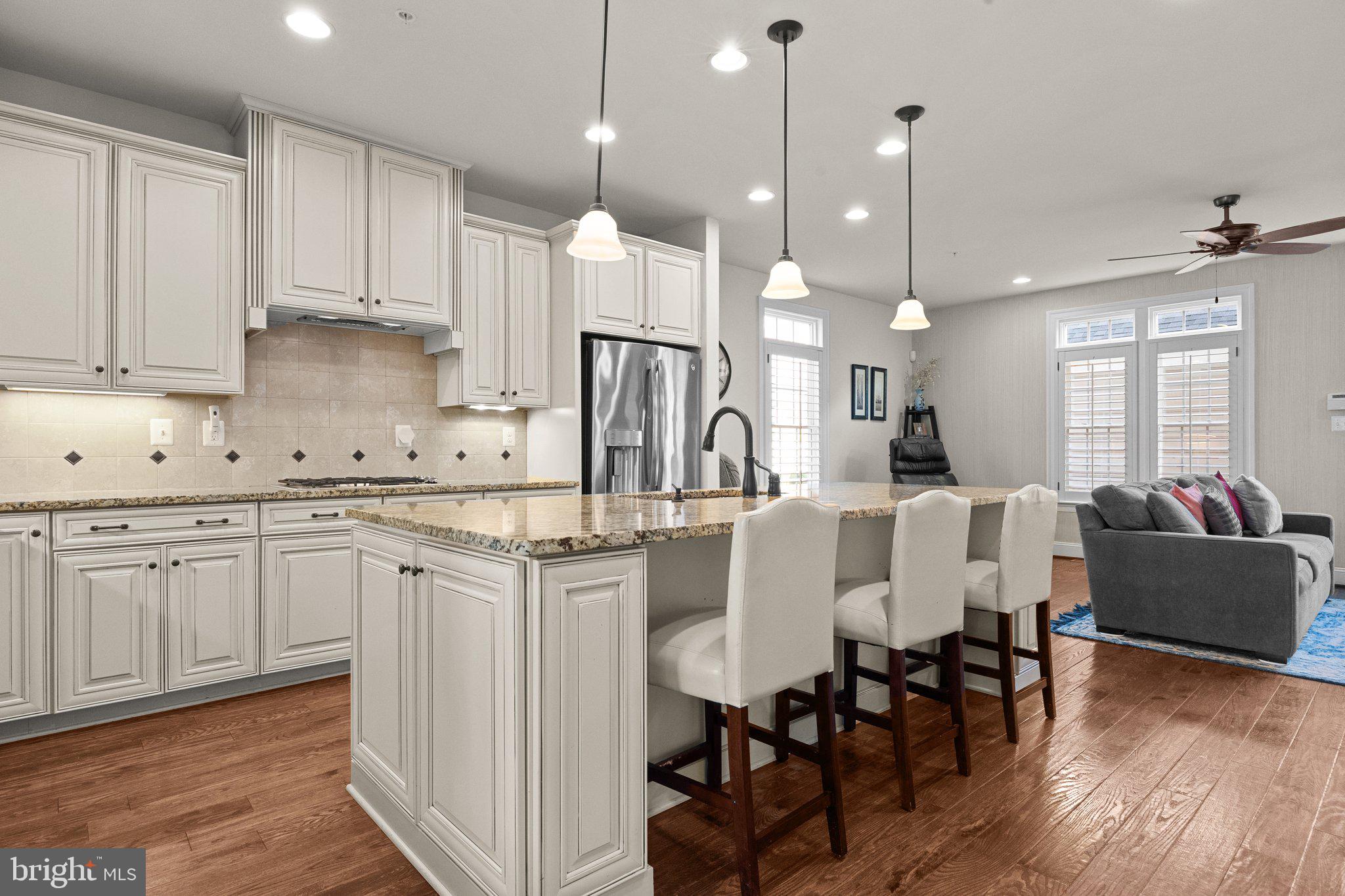 3842 Jacob Stout Road Doylestown, PA 18902 - Photo 6 of 68 a kitchen with stainless steel appliances kitchen island granite countertop a table chairs sink and cabinets