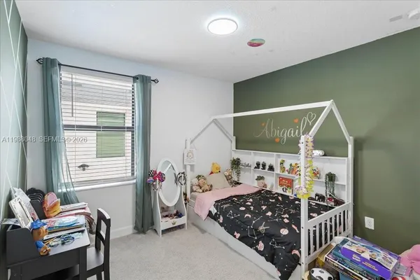 a bedroom with furniture and a window