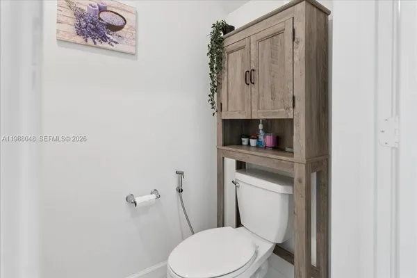 a white toilet sitting next to a bathroom sink