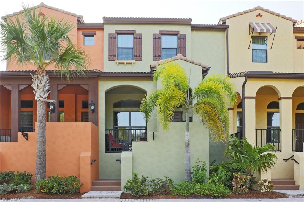 9051 Capistrano Street North, Unit 4308 Naples, FL 34113 - Photo 1 of 20 a front view of a house with outdoor seating and plants