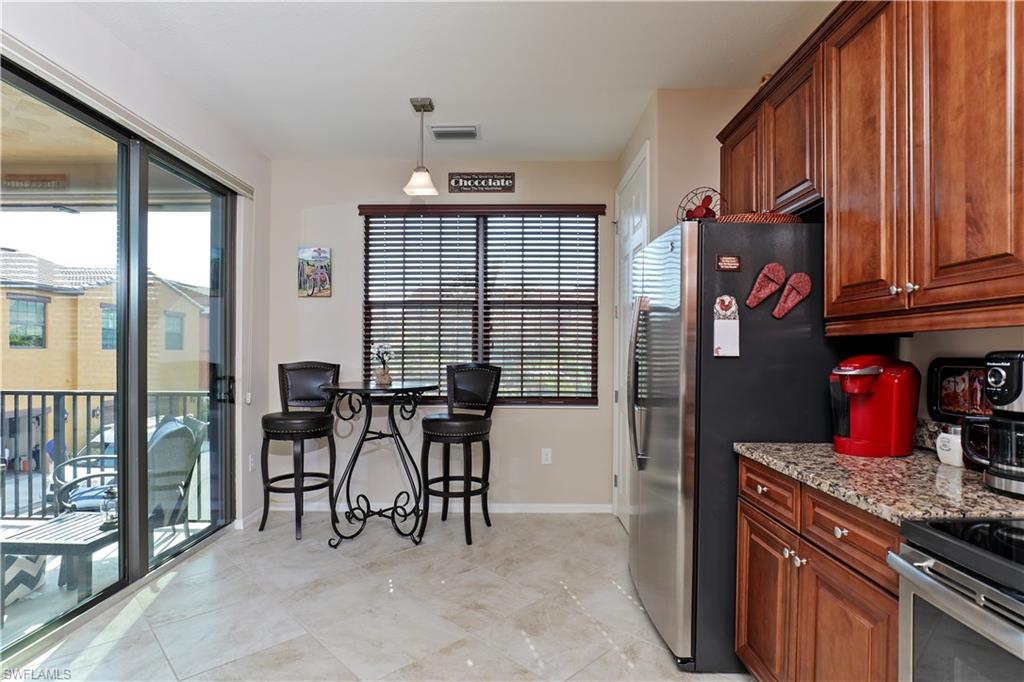9051 Capistrano Street North, Unit 4308 Naples, FL 34113 - Photo 2 of 20 a view of a dining room with furniture window and outside view