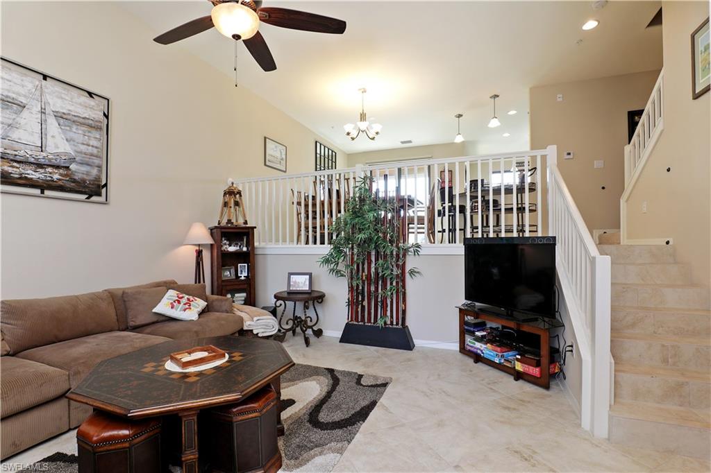 9051 Capistrano Street North, Unit 4308 Naples, FL 34113 - Photo 5 of 20 a living room with furniture and a flat screen tv