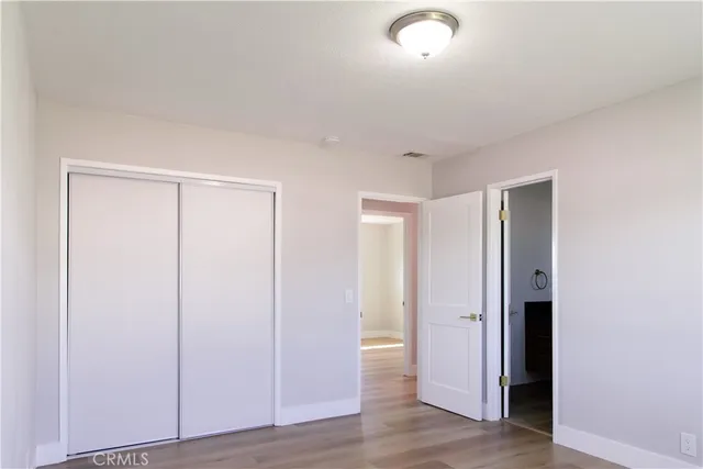 a view of an empty room and wooden floor