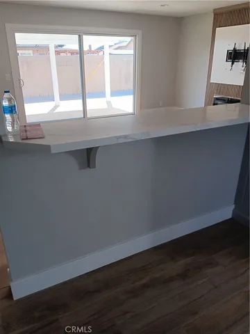 a view of wooden floor and cabinets in a room