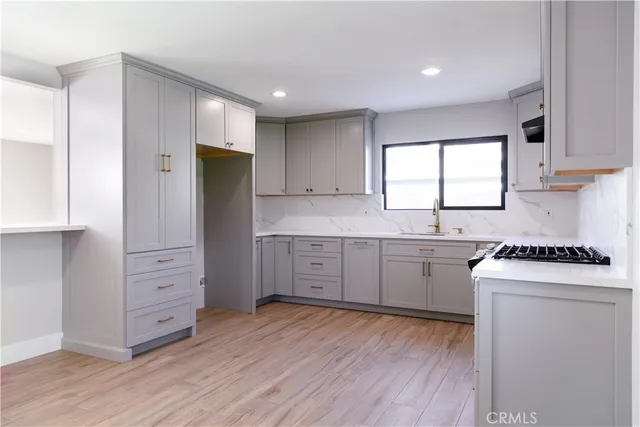 a kitchen with white cabinets and white appliances