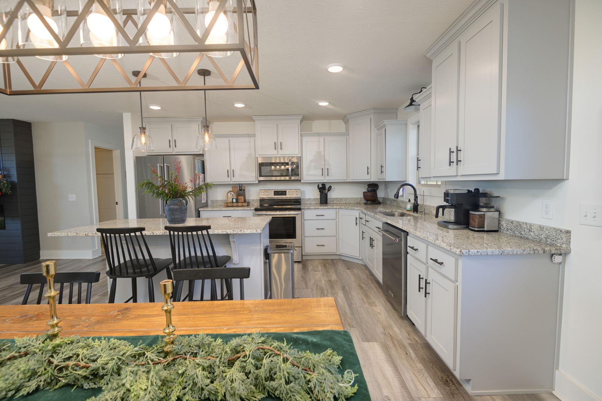 720 Armstrong Road Castalian Springs, TN 37031 - Photo 13 of 45 a kitchen with stainless steel appliances kitchen island granite countertop a dining table chairs and view living room
