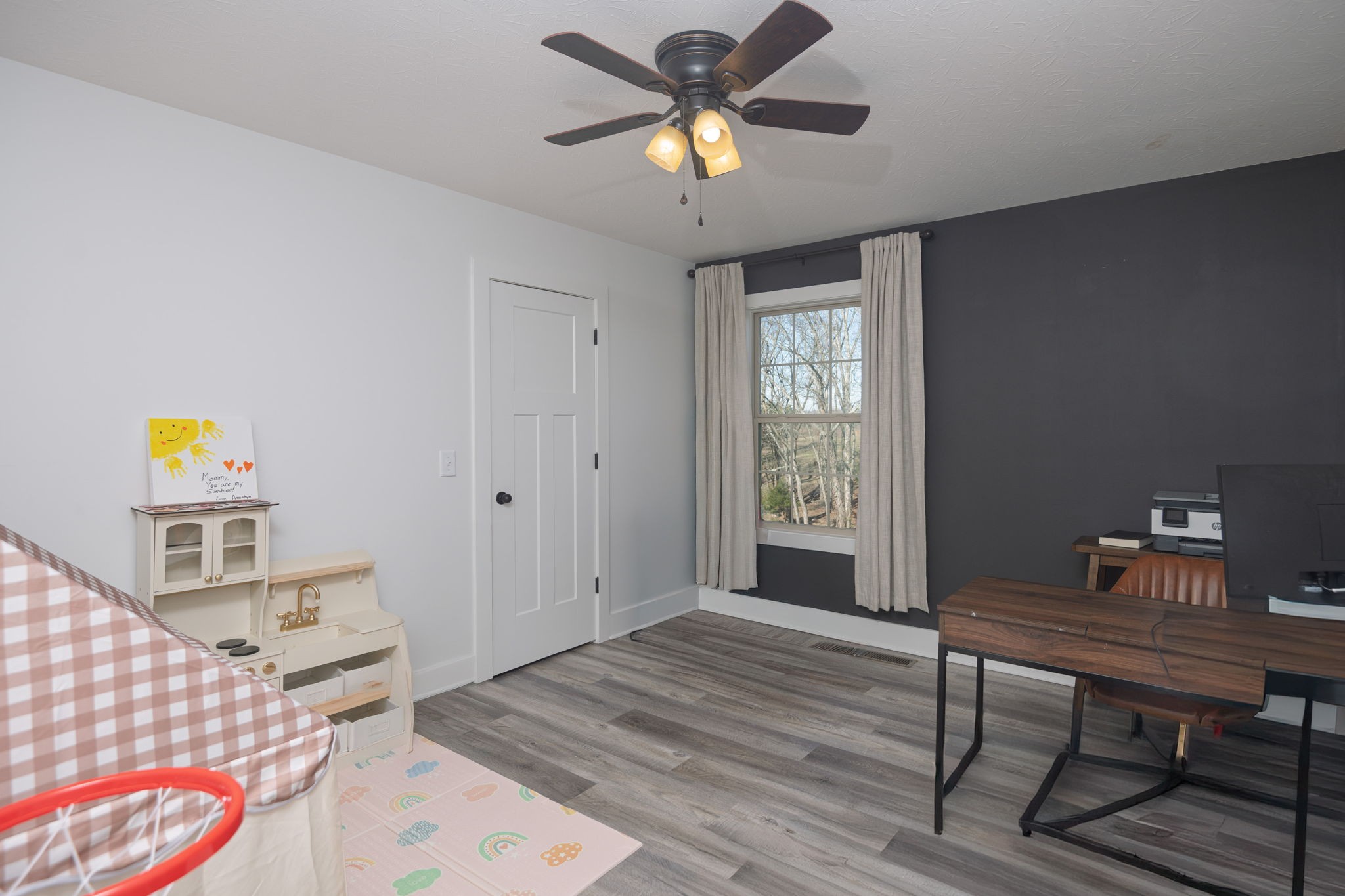 720 Armstrong Road Castalian Springs, TN 37031 - Photo 33 of 45 a workspace with wooden floor and a chandelier fan