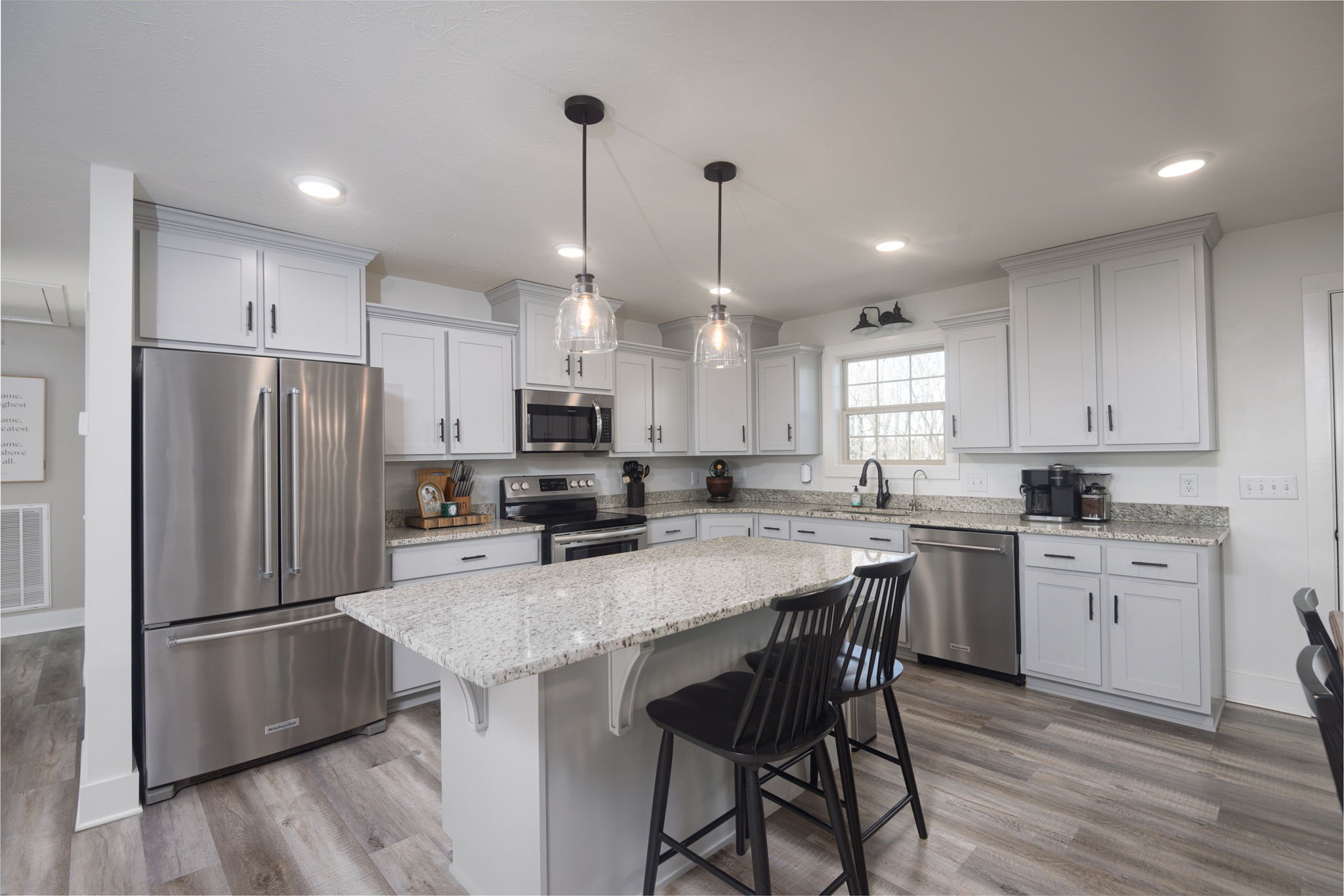 720 Armstrong Road Castalian Springs, TN 37031 - Photo 9 of 45 a kitchen with kitchen island a refrigerator a stove a sink and chairs
