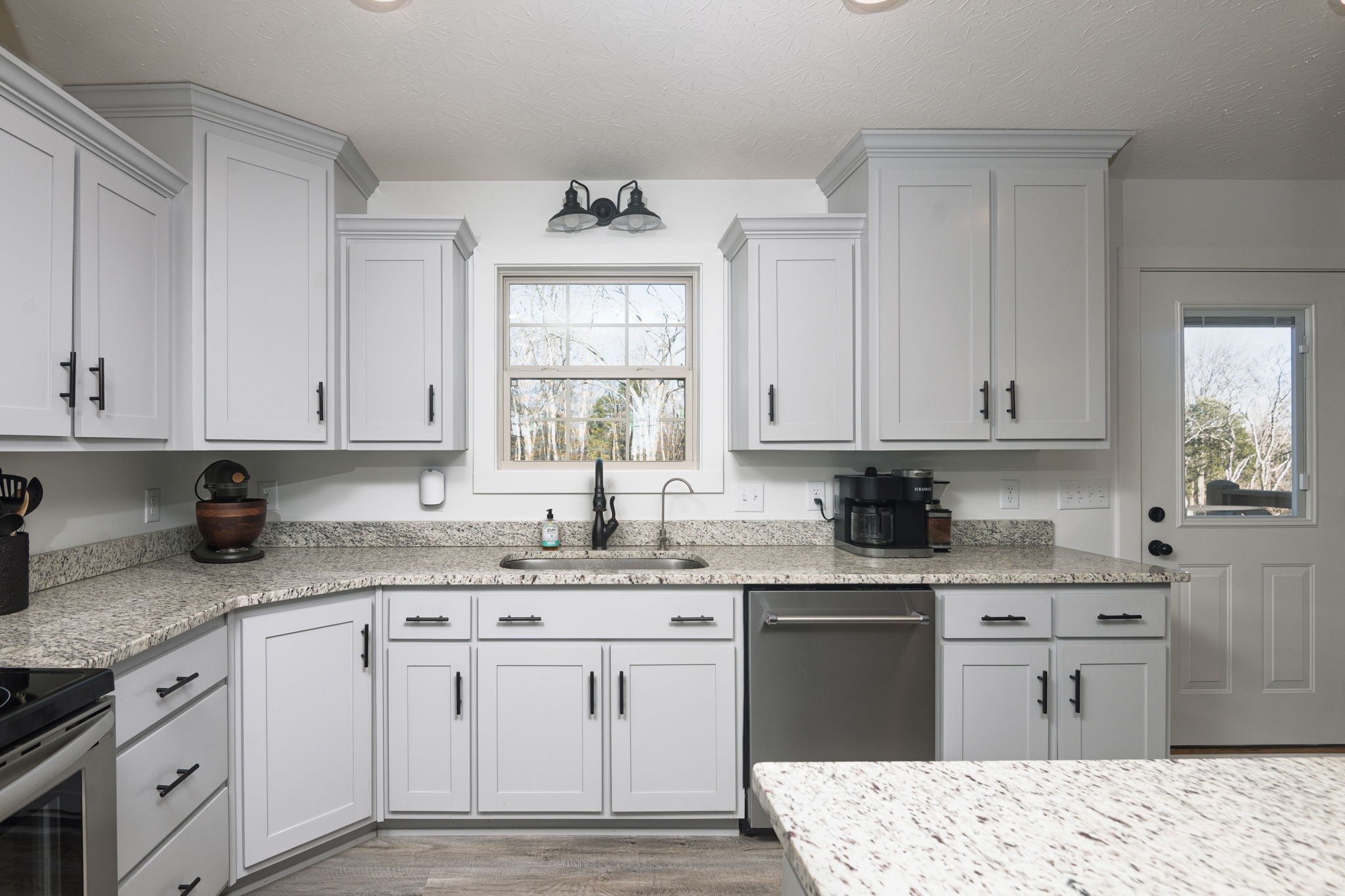 720 Armstrong Road Castalian Springs, TN 37031 - Photo 10 of 45 a kitchen with granite countertop white cabinets white appliances and sink