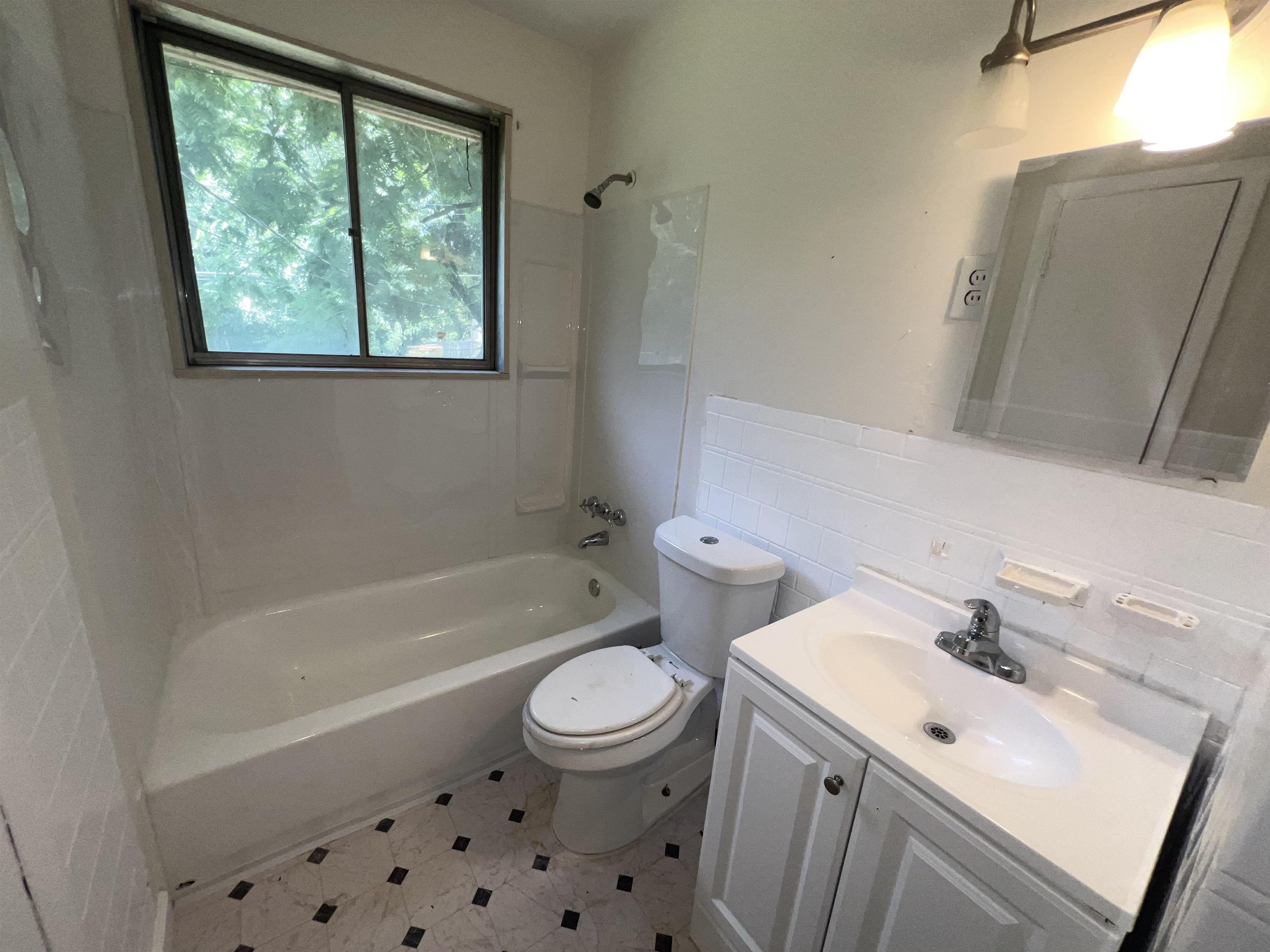 2235 Charjean Road Memphis, TN 38114 - Photo 8 of 15 Full bath with tile walls, vanity, and shower / bath combination