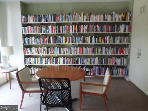 a view of a dining room with furniture and a bookshelf