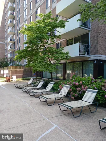 a view of a patio with couches table and chairs and potted plants