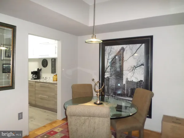 a dining room with furniture a chandelier and window