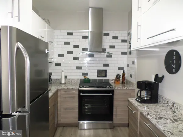 a kitchen with a stove and a refrigerator