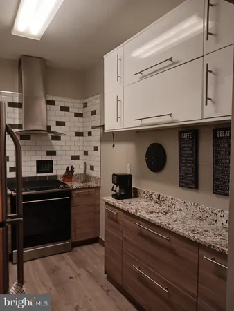 a kitchen with a stove and a refrigerator
