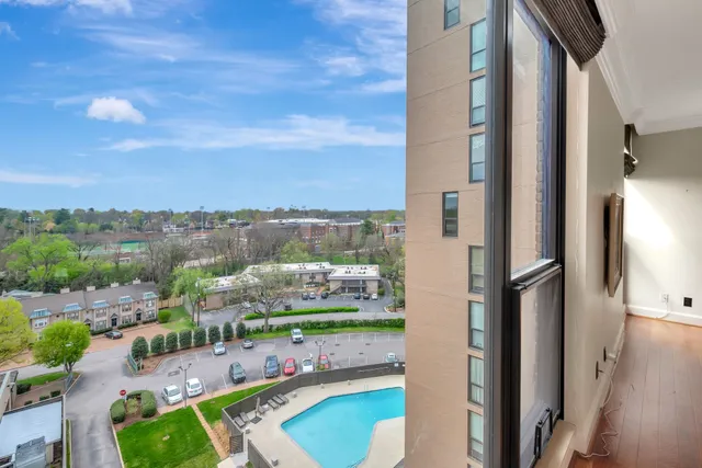 a view of a livingroom with wooden floor and lounge chair