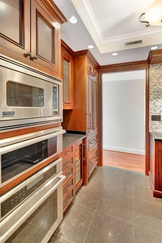 a kitchen with a sink and a mirror