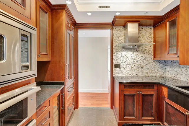 a kitchen with stainless steel appliances granite countertop a sink and cabinets