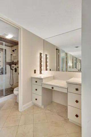 a spacious bathroom with a granite countertop sink mirror and shower