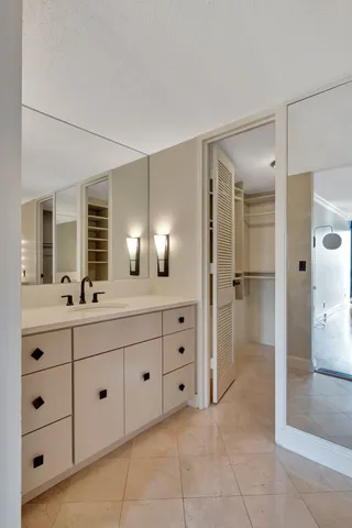 a bathroom with a tub sink and mirror