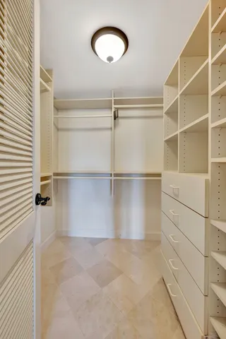 a living room with furniture a flat screen tv and a floor to ceiling window