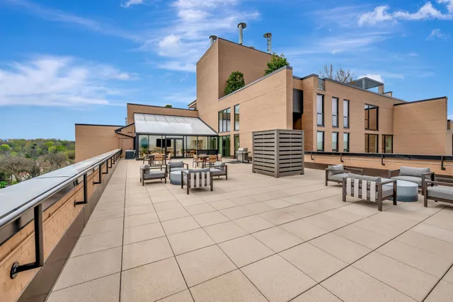 a room with wooden floor pool table and furniture