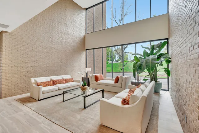 a living room with furniture and a potted plant