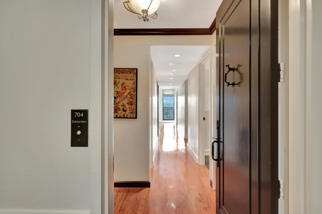 a view of a hallway with wooden floor