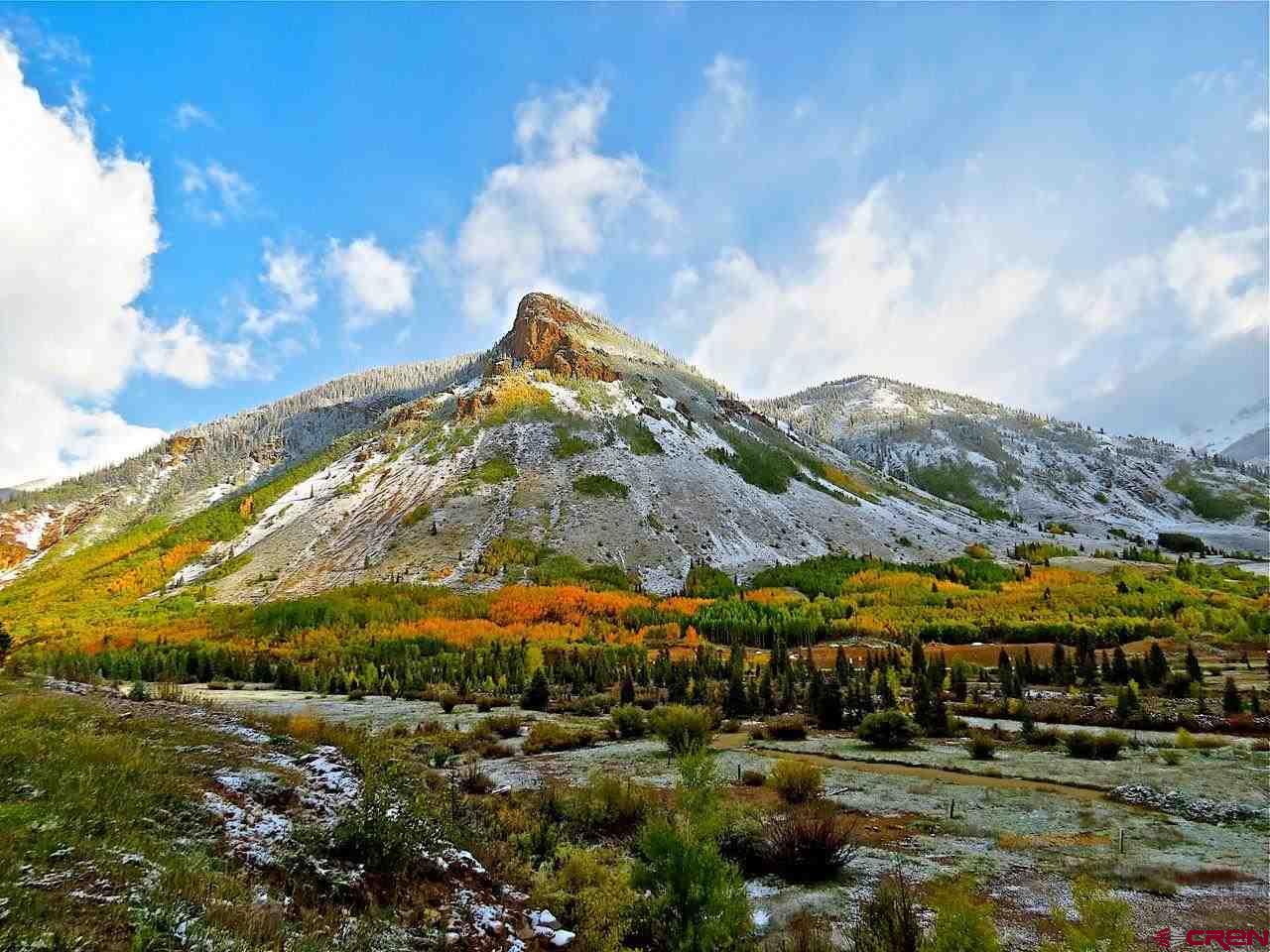a view of a town with mountains in the background