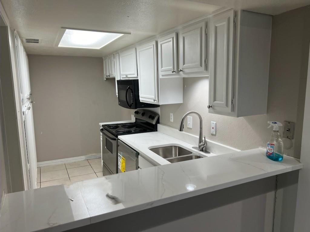 a kitchen with stainless steel appliances granite countertop a sink and a stove top oven