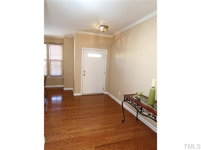 7843 Spungold Street Raleigh, NC 27617 - Photo 1 of 20 a view of an empty room with wooden floor and a window