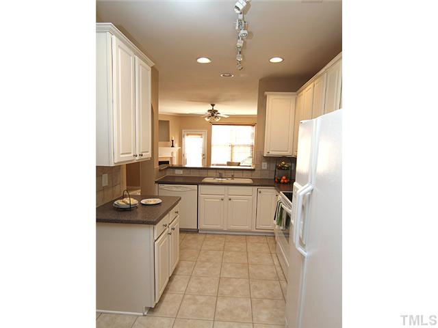 7843 Spungold Street Raleigh, NC 27617 - Photo 10 of 20 a kitchen with a sink cabinets and window