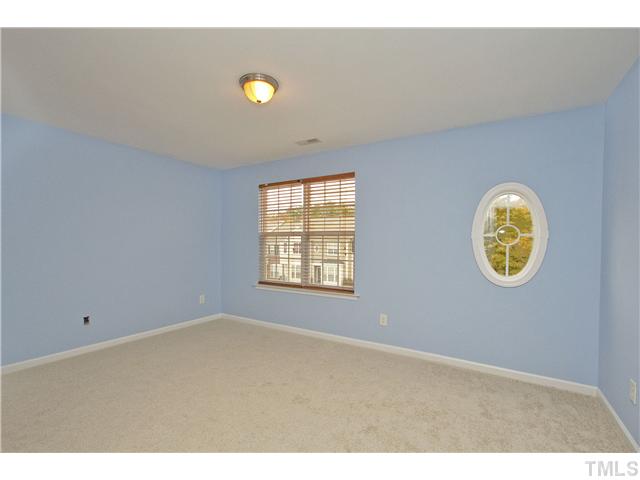 7843 Spungold Street Raleigh, NC 27617 - Photo 15 of 20 a view of an empty room with window and wooden floor