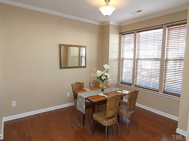 7843 Spungold Street Raleigh, NC 27617 - Photo 2 of 20 a dining room with furniture and window