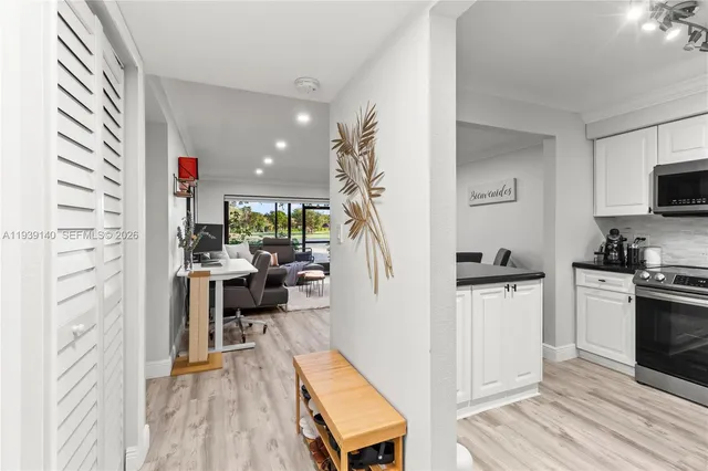 a view of kitchen with furniture and wooden floor