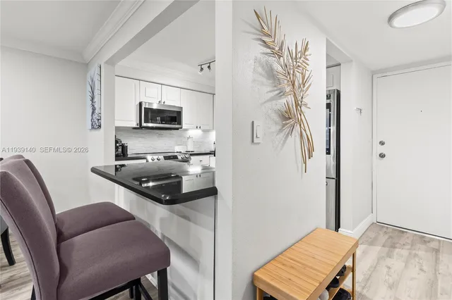 a kitchen with stainless steel appliances a stove a microwave and a refrigerator