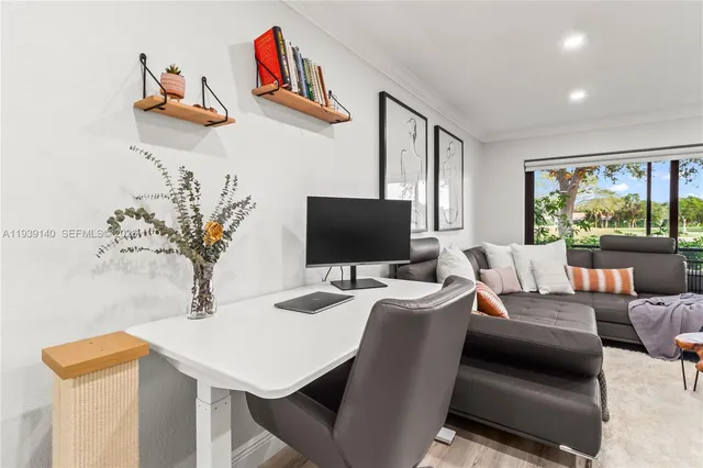 a view of a livingroom with furniture and a flat screen tv