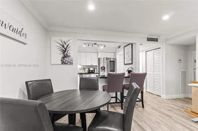 a view of a dining room with furniture and wooden floor