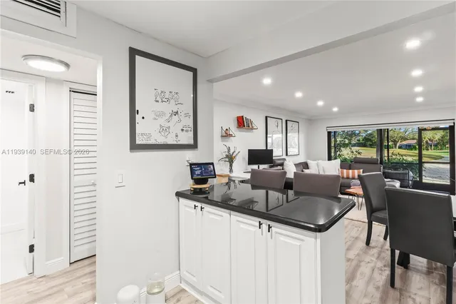 a large white kitchen with a large window