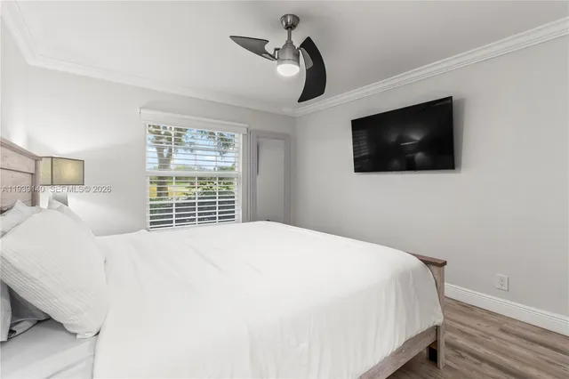 a bedroom with a large bed and a flat screen tv