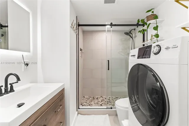 a bathroom with a sink and a washing machine