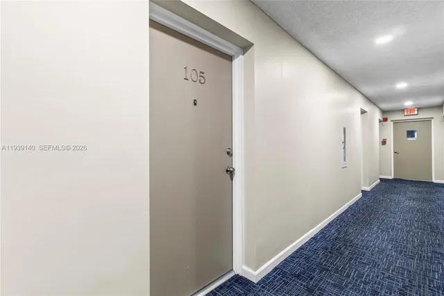 a spacious bedroom with a bed and glass window