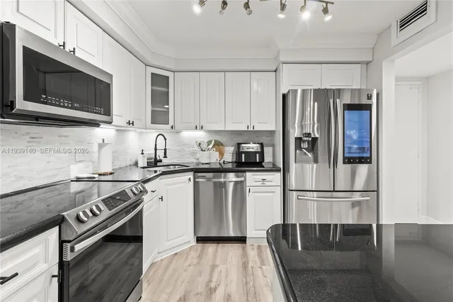 a kitchen with a refrigerator stove and microwave