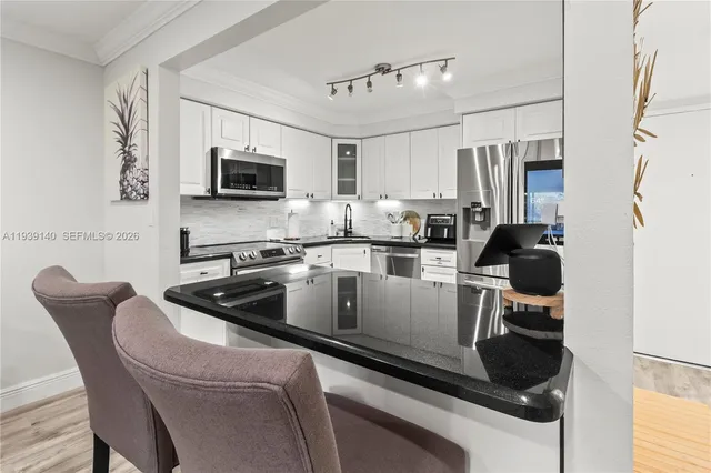 a kitchen with a sink cabinets and appliances