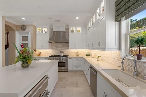a kitchen with a sink cabinets and window