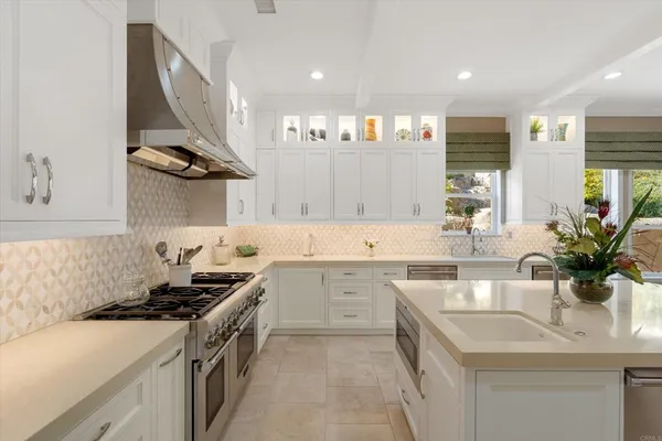 a living room with fireplace furniture and a large window