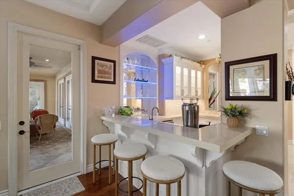 a living room with patio furniture and a large window