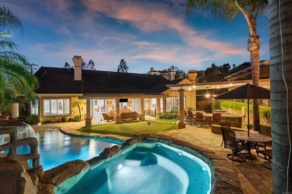 a view of a swimming pool with outdoor seating