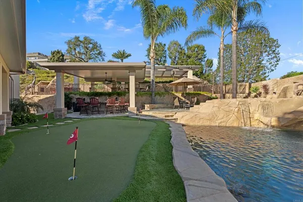 a spacious bedroom with a large bed and a chandelier