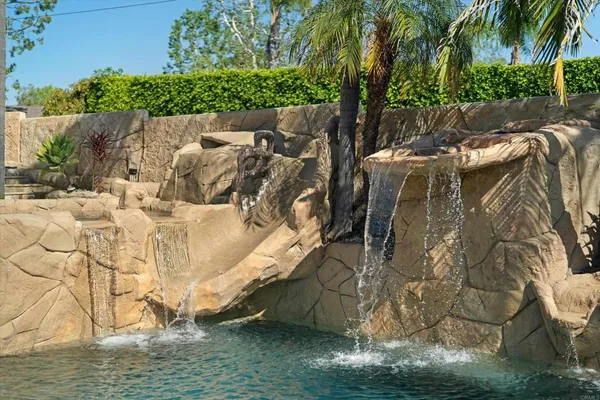 a bedroom with a bed and a flat screen tv with wooden floor